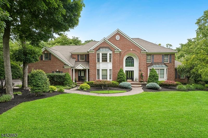 Brick-front Colonial and landscaped grounds at 3 Forest Hill Drive in Sparta